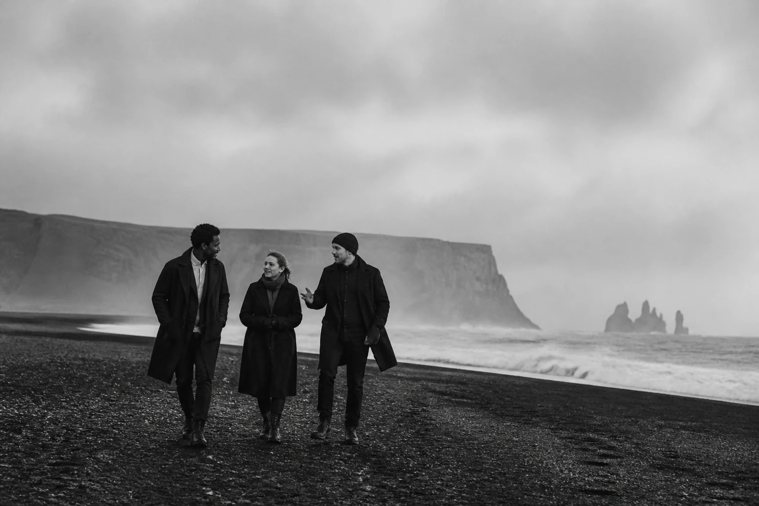Tres personas caminando junto a la costa atlántica.